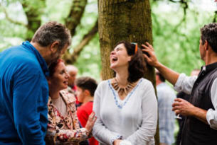 Group chatting and laughing in a wood