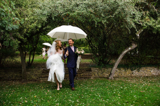 Bridal couple under umbrella