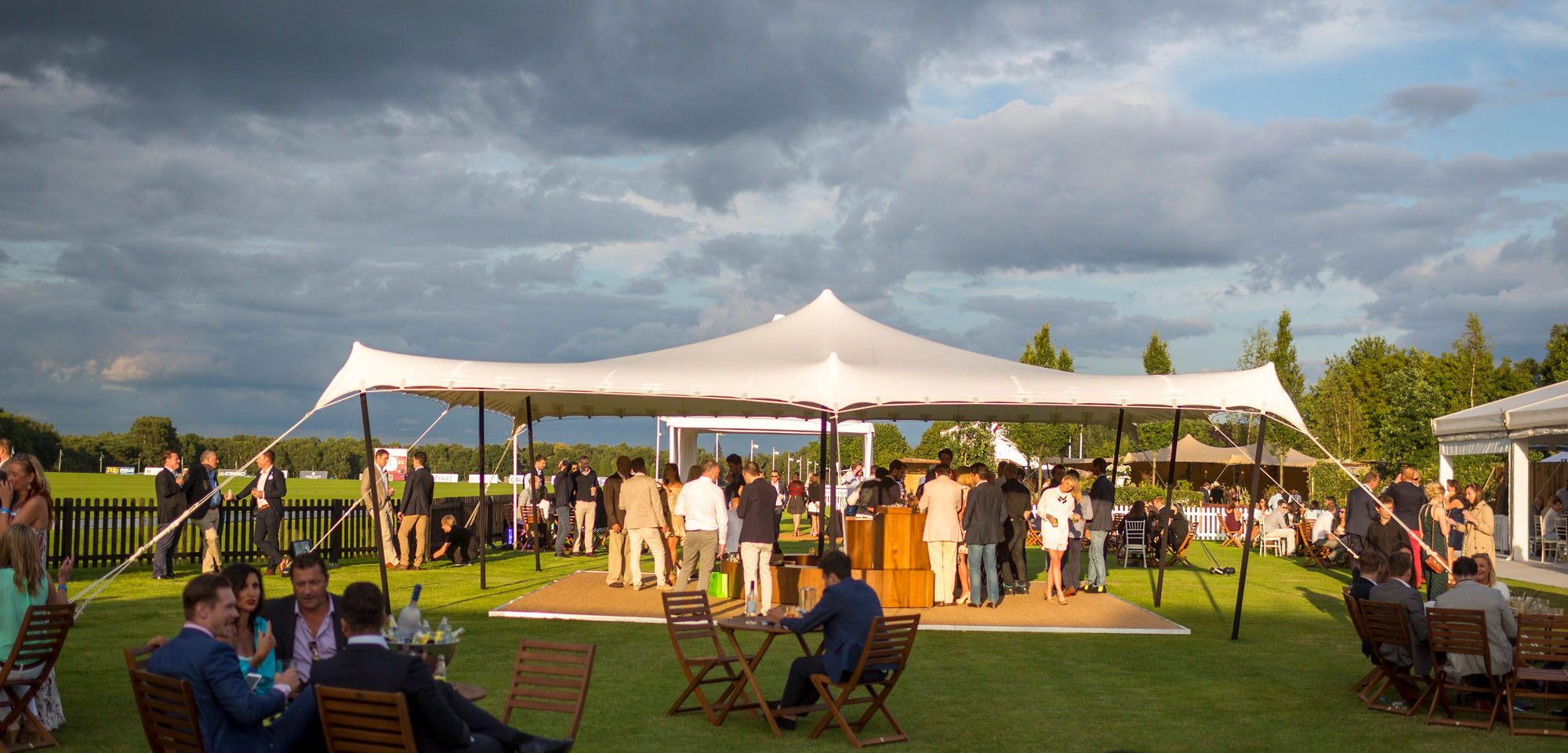 white stretch tent covering a bar at a polo event